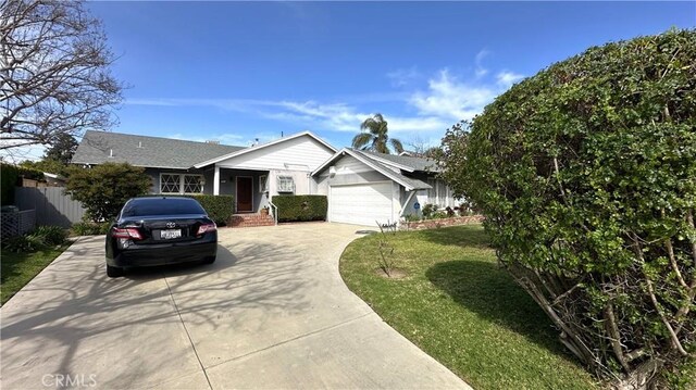 single story home featuring a garage, concrete driveway, a front yard, and fence