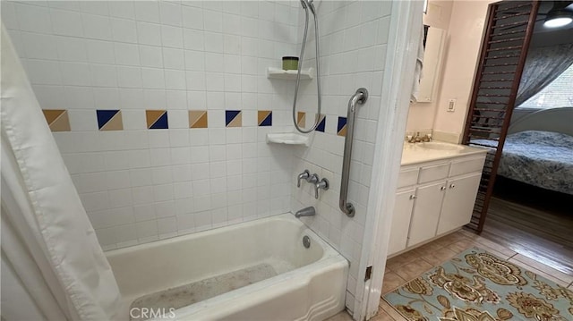 full bath with tile patterned floors, vanity, and shower / tub combo