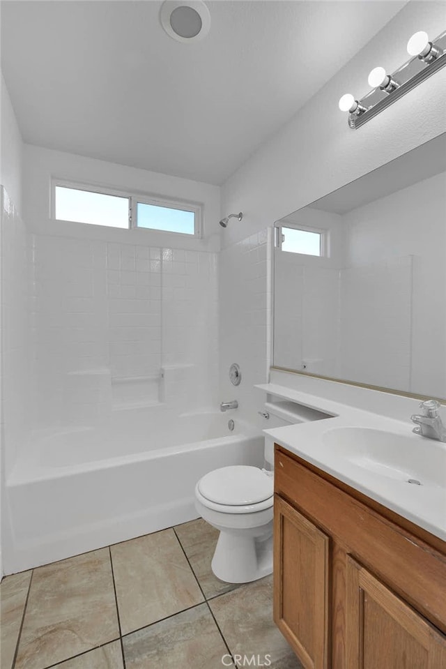 bathroom featuring tile patterned floors, toilet, washtub / shower combination, and plenty of natural light