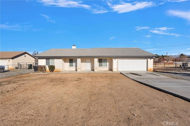 ranch-style house with fence, a garage, driveway, and stucco siding