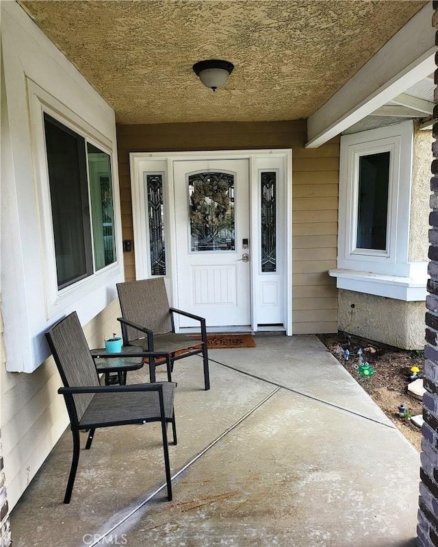 property entrance featuring a porch