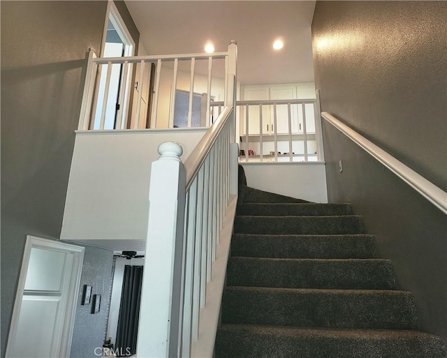 staircase featuring recessed lighting