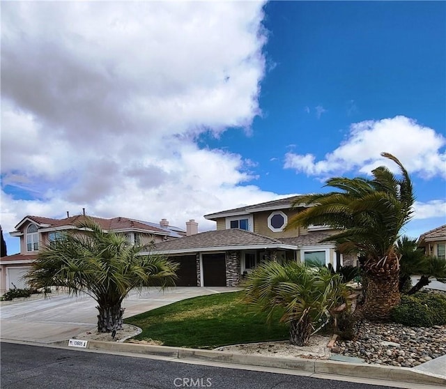 view of front of property with concrete driveway and a garage