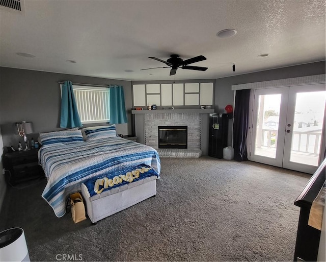 bedroom featuring visible vents, french doors, a fireplace, carpet flooring, and access to exterior