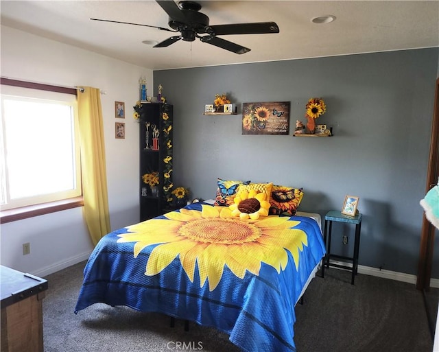 carpeted bedroom featuring a ceiling fan and baseboards