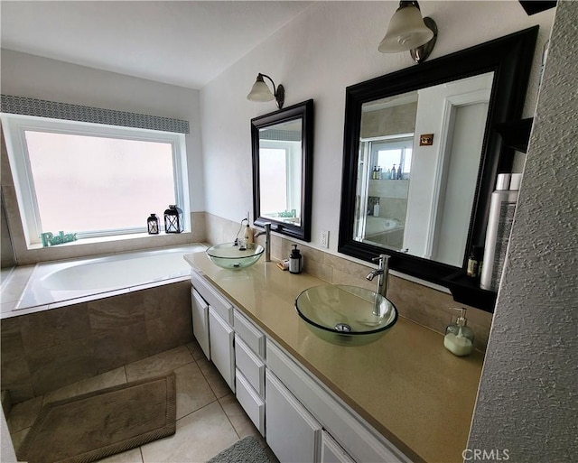 bathroom featuring tile patterned flooring, a wealth of natural light, and a sink