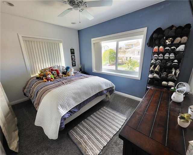 carpeted bedroom with baseboards and ceiling fan