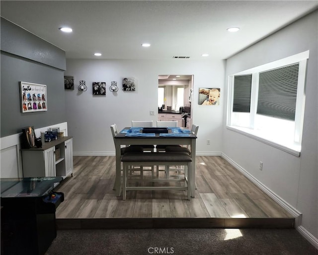 dining space featuring a wealth of natural light, visible vents, and wood finished floors