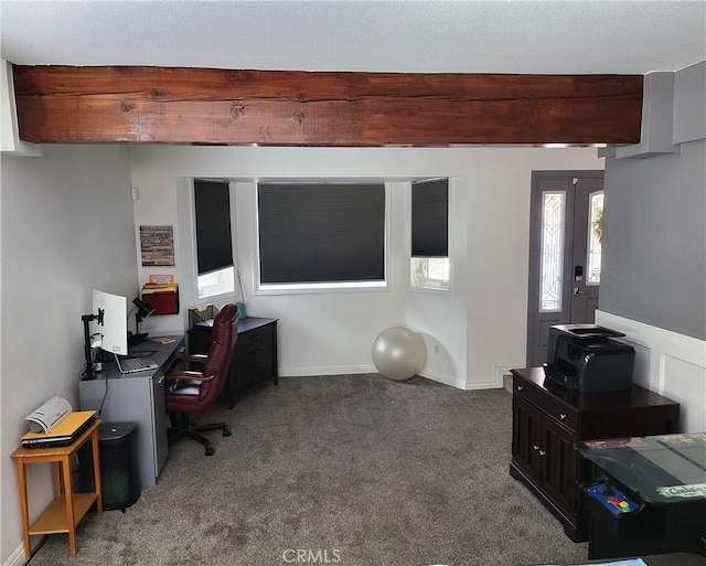 carpeted home office featuring beamed ceiling and baseboards