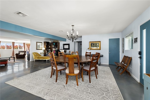 dining space with a chandelier, concrete floors, baseboards, and visible vents