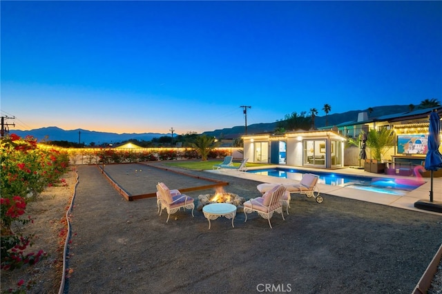 outdoor pool with a patio area, an exterior structure, and an outdoor structure
