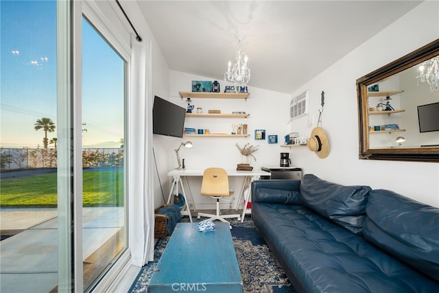 living room with built in desk, a chandelier, and lofted ceiling