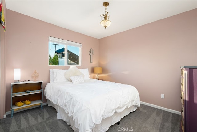 carpeted bedroom featuring baseboards