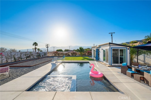 view of swimming pool featuring a fenced backyard, an outdoor structure, a fenced in pool, and a storage structure