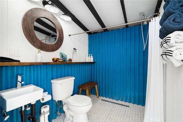 bathroom with a sink, toilet, tile patterned flooring, and a shower with curtain