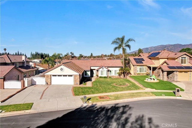 view of front of house featuring a front yard, a gate, a residential view, and driveway