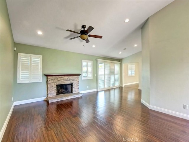 unfurnished living room featuring baseboards, lofted ceiling, wood finished floors, and a fireplace