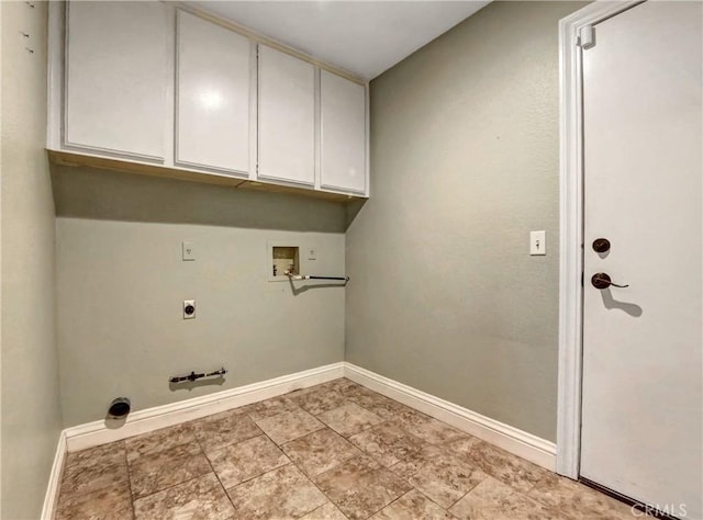 clothes washing area with hookup for a washing machine, baseboards, hookup for an electric dryer, gas dryer hookup, and cabinet space