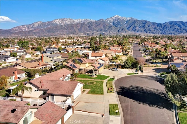 birds eye view of property with a mountain view and a residential view