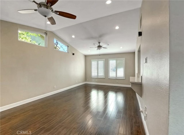 unfurnished living room with dark wood-type flooring, baseboards, lofted ceiling, recessed lighting, and a ceiling fan