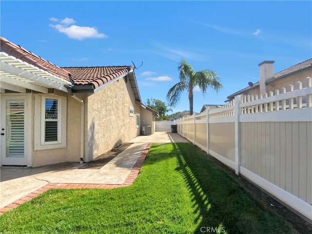 view of yard with a patio area and a fenced backyard