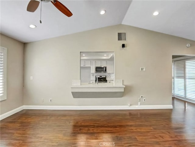 unfurnished living room with visible vents, lofted ceiling, baseboards, and wood finished floors