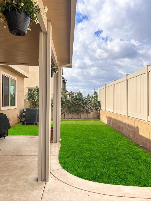 view of yard featuring a patio, central AC unit, and a fenced backyard