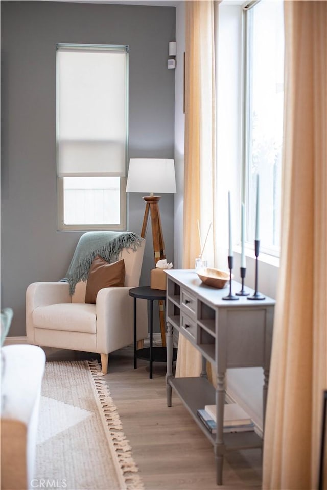 sitting room featuring plenty of natural light and wood finished floors