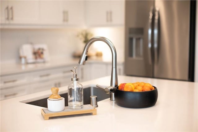 room details with stainless steel refrigerator with ice dispenser and light countertops