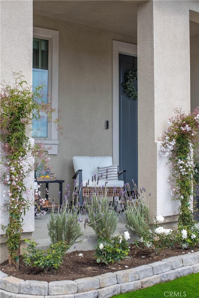 property entrance with stucco siding