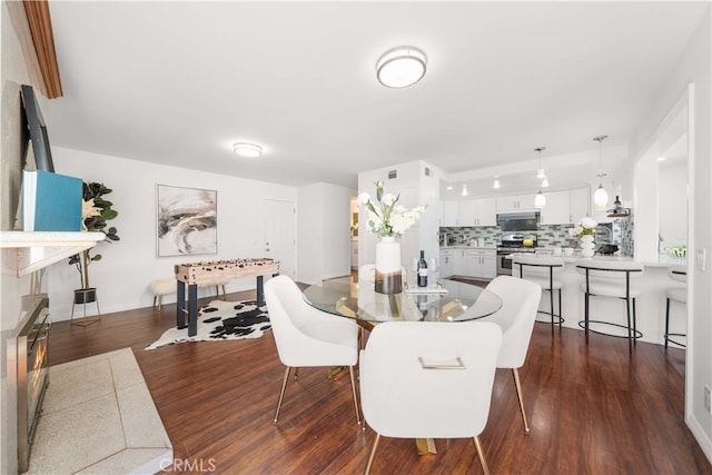 dining space featuring dark wood-style floors