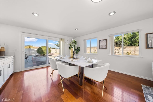 dining area with recessed lighting, baseboards, plenty of natural light, and wood-type flooring