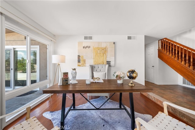 office featuring visible vents, baseboards, and wood finished floors