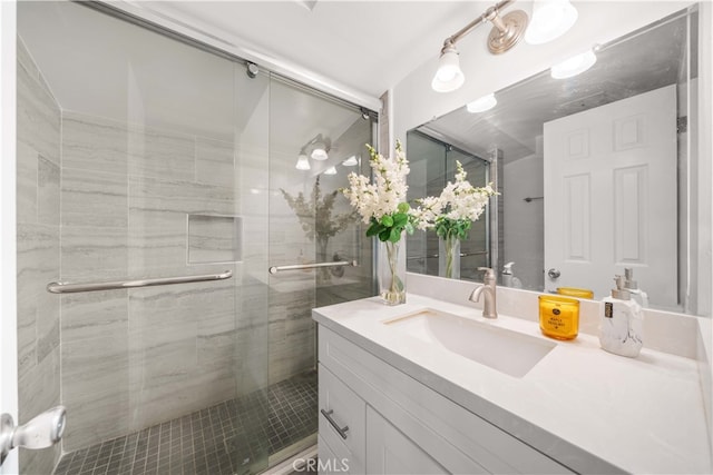 full bathroom featuring a stall shower and vanity