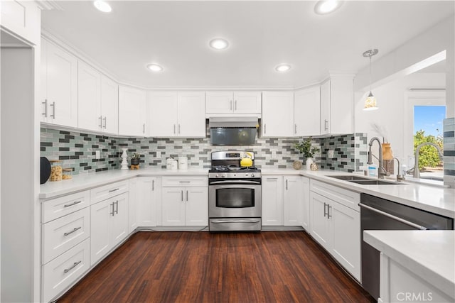 kitchen with light countertops, white cabinets, appliances with stainless steel finishes, and a sink