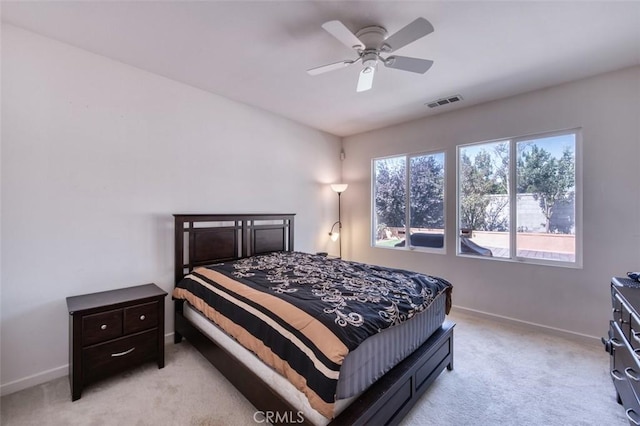 bedroom featuring visible vents, light carpet, baseboards, and ceiling fan