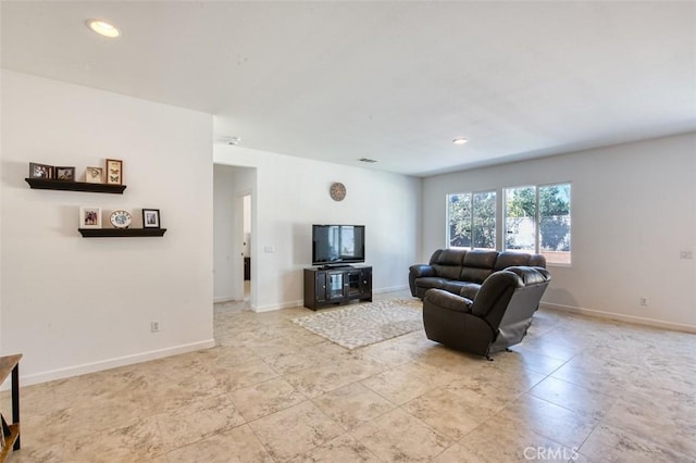 living area featuring recessed lighting and baseboards