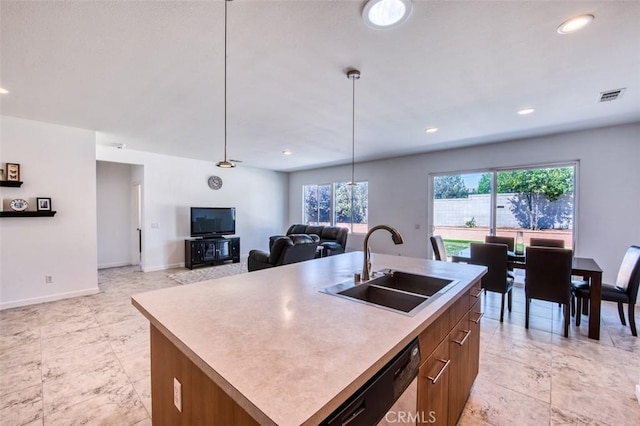 kitchen with visible vents, pendant lighting, a sink, baseboards, and dishwasher