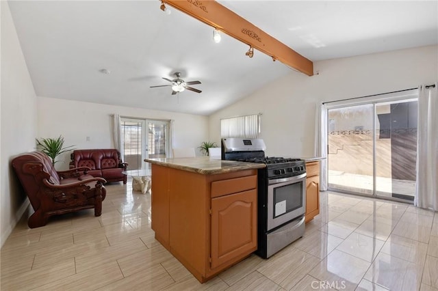 kitchen with ceiling fan, open floor plan, lofted ceiling with beams, french doors, and stainless steel gas range