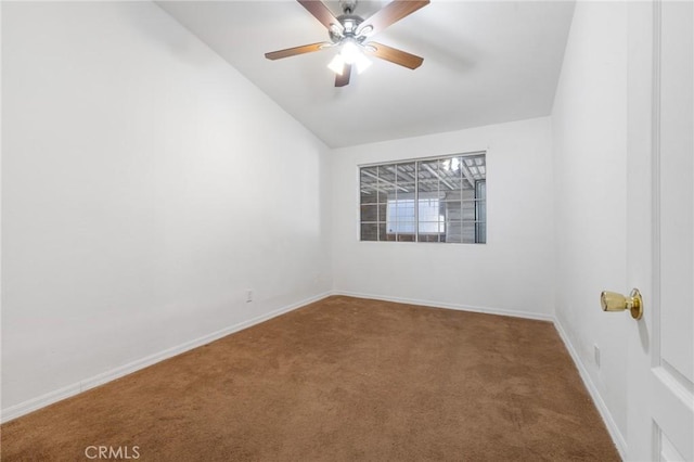 carpeted empty room with baseboards, ceiling fan, and vaulted ceiling