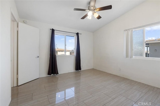 spare room featuring lofted ceiling and ceiling fan