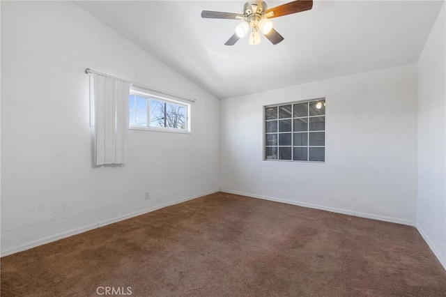 spare room with baseboards, carpet, ceiling fan, and vaulted ceiling