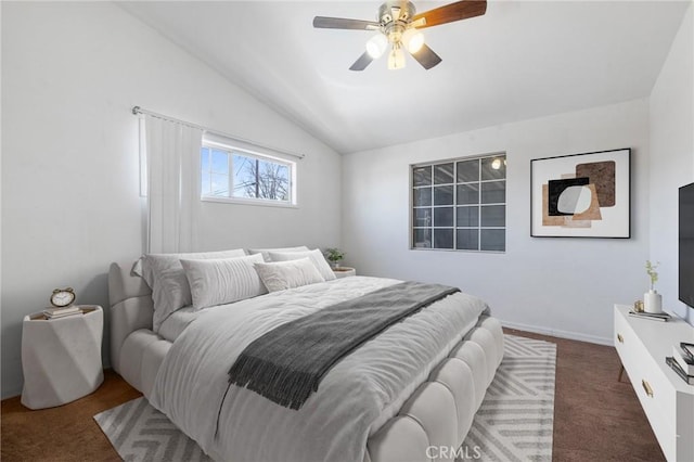 bedroom featuring baseboards, lofted ceiling, carpet floors, and ceiling fan