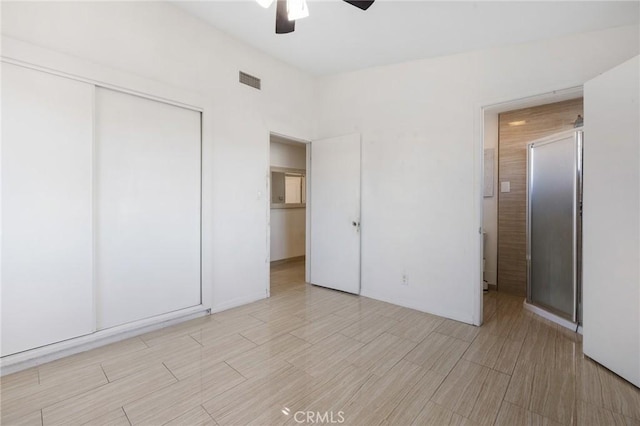 unfurnished bedroom featuring a closet, visible vents, ceiling fan, and wood tiled floor