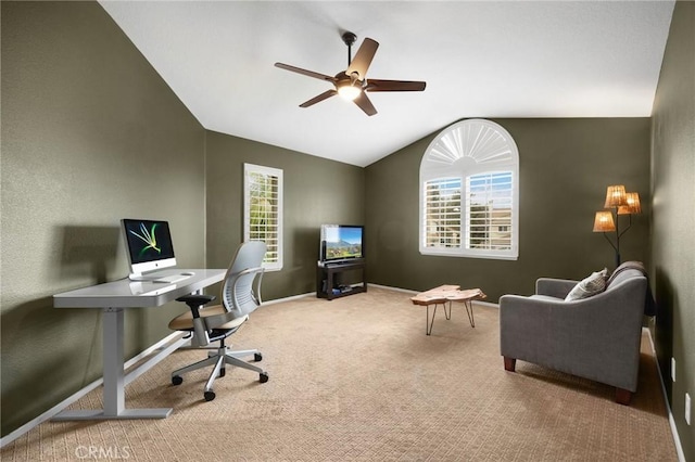 office area featuring baseboards, lofted ceiling, carpet, and ceiling fan