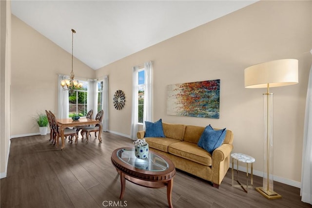 living area featuring wood finished floors, baseboards, and a chandelier