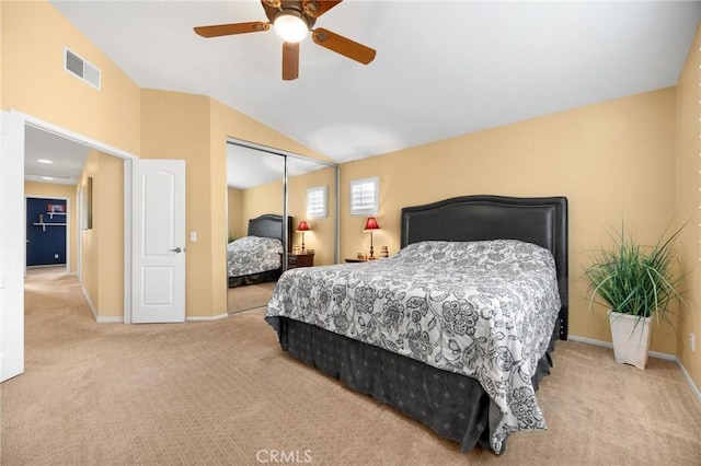 carpeted bedroom featuring baseboards, visible vents, ceiling fan, vaulted ceiling, and a closet