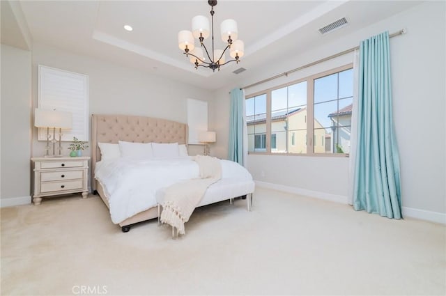 bedroom featuring visible vents, carpet flooring, a raised ceiling, and an inviting chandelier