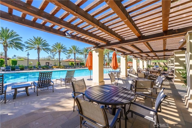 view of patio / terrace featuring a pergola and a community pool