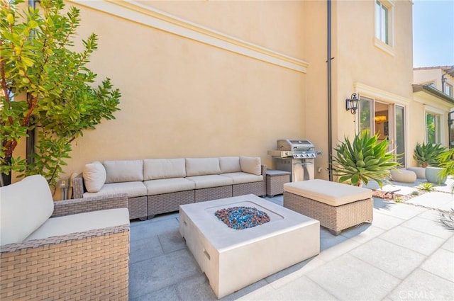 view of patio with an outdoor living space with a fire pit and a grill